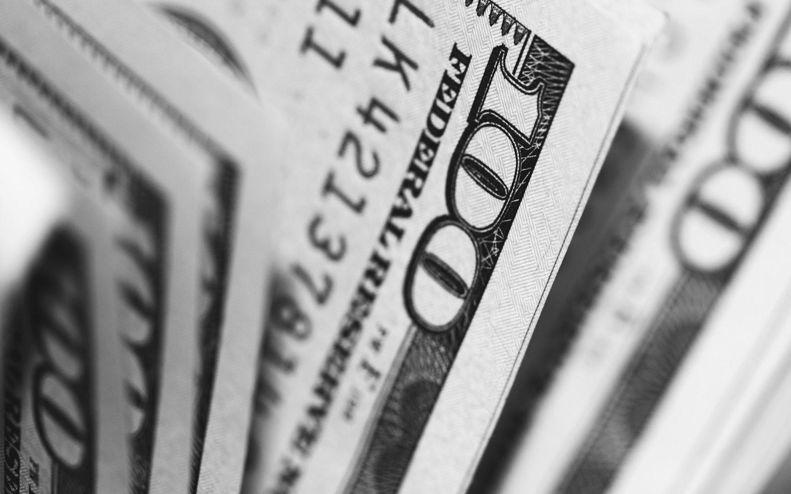 closeup photo of 100 US dollar banknotes depicting actual cash value